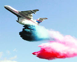 A Russian-made Beriev Be-200ChS amphibious aircraft dumps coloured water as Russian state flag during a demonstration flight at the international air show Gydroaviasalon  2010 in the Black Sea town of Gelendzhik on Sunday. 