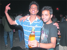 Two youths enjoy beer in the open at Sector 22.
