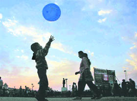 A child silhouettes against the setting sun in Shimla on Sunday. 