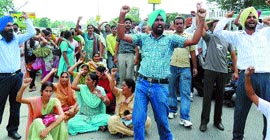 ETT teachers stage a dharna on the Jalandhar-Amritsar highway at Kartarpur on Sunday.