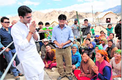 Minister of State for Communications and Information Technology Sachin Pilot interacts with the flood-hit victims at the Solar Valley relief camp in Choglamsar on Sunday