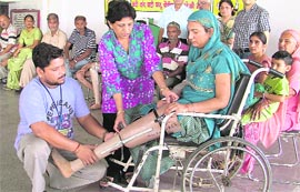 A woman being given an artificial foot during a camp in Ludhiana on Sunday.