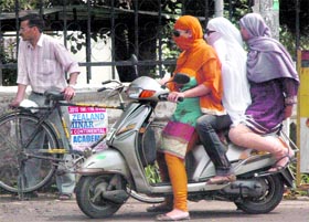 Girls triple riding in Patiala on Sunday.
