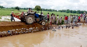 Villagers trying to plug breach in Pakka minor of Kotla branch canal in Bathinda on Sunday.