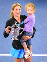 Kim Clijsters from Belgium with her daughter Jada after defeating Russias Vera Zvonareva in the women's singles final at US Open in New York on Saturday. 