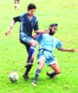 Players vie for the ball during a football match at Panjab University