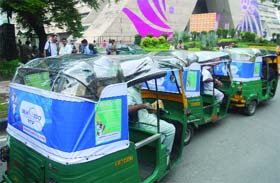 Commonwealth Games advertisement sheets put atop autorickshaws in New Delhi