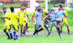 Players vie for the ball at the SGRR Sahodya Complex Football Tournament in Dehradun on Monday.