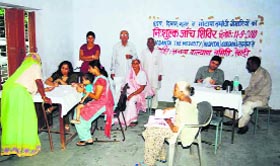 Doctors examine patients at a medical camp in Rewari.