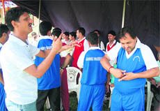 Players of Jammu Warriors team converse with each other with actions during a cricket tournament for the physically challenged organised by the state police at MAM Stadium in Jammu on Monday.