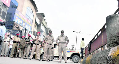 Policemen patrol a street at Field Gunj.