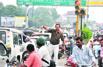 Suresh Kumar, a resident of Delhi, tries to regulate traffic in Ludhiana.