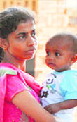 The woman consoles her child amid protest. 
