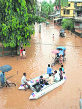 Rescuers use inflatable boats to shift flood-affected people of Nabin Nagar to safer places in Guwahati on Monday. 