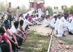 Activists of the All-India Jat Reservation Struggle Committee sit on a railway line in Ferozepur on Monday.