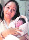 A nurse poses with a newborn baby found inside the lavatory of an airplane at Manila's Ninoy Aquino International Airport on Sunday.
