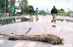 Security forces patrol the highway to Jammu, in Srinagar on Tuesday.