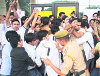 BDA students of Indira Gandhi Government Dental College scuffle with the police in protest against the de-recognition of their batch by the Dental Council of India, in Jammu on Tuesday.
