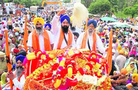 Devotees take part in a procession to mark the 523rd marriage anniversary of Guru Nanak Dev at Batala
