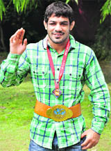 Wrestler Sushil Kumar poses with his medal in New Delhi 