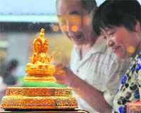 A gold statue of the Buddhist goddess Guanyin is seen at a store in Hefei, Anhui province