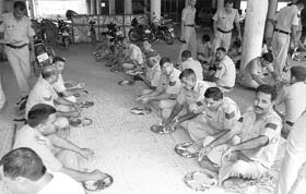 Policemen deployed at Gurdwara Nada Sahib, Panchkula, following threat by the Haryana SGPC (Ad-hoc) to take over gurdwaras in the state, partake of food at a sarai