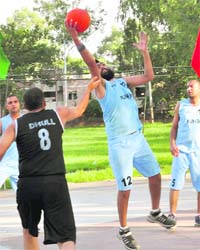 A Punjab cager tries to put the ball in the basket during a match against Haryana in the 24th All-India Basketball Tournament 2010-11 at Sports Complex, Sector 7
