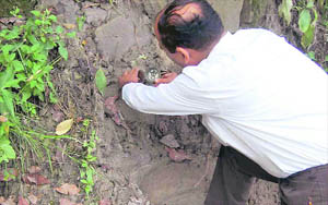 An expert inspects a landslide-prone spot in Haridwar on Wednesday.
