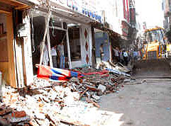 A JCB removes encroachments at Sheikhan Bazaar in Jalandhar on Wednesday.