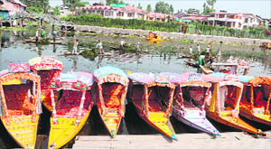 Shikaras await customers in the Dal Lake in Srinagar on Wednesday. The tourism in the Valley has been severely hit due to the continuous strikes and curfews during the past three months.