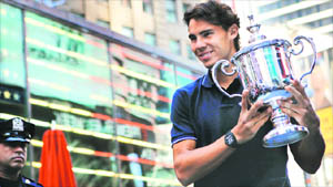 Rafael Nadal of Spain, winner of the 2010 US Open Tennis Tournament, poses with the trophy at Times Square in New York on Tuesday.