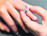A Sothebys employee displays an extremely rare Van Cleef and Arpels 6.43 carat vivid pink diamond ring at the auction house in London on Thursday. It is expected to fetch $6-7 million when it goes under the hammer in Hong Kong on October 6