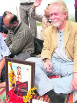 Tom Alter sits in protest near a demolished heritage Clock Tower in Mussoorie