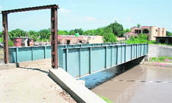 A view of the bridge, constructed by the Department of Irrigation and Flood Control, connecting the upcoming palatial bungalow of Health Minister Sham Lal Sharma with the Jammu-Poonch Highway near Mishriwala.