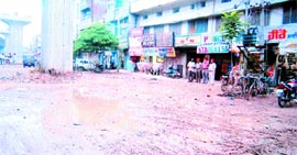 The dilapidated condition of the road opposite the shops under the elevated road opposite the bus stand in Amritsar.