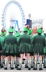 Bavarian men in traditional attire watch a horse race to celebrate 200 years of Oktoberfest, one day before the opening in Munich