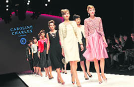Models walk down the catwalk wearing clothes by Caroline Charles for the Spring/Summer 2011 collection on the first day of the London Fashion Week, in London,