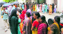 Patients wait outside a medical store at the Doon Hospital in Dehradun on Thursday.