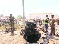 Security personnel stand next to a truck destroyed in an explosion in Batticaloa, 320 km east of Colombo on Friday