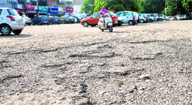 A potholed road at the Phase 3B-2 market in Mohali