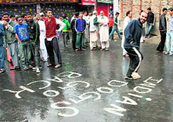 Youths protest during the curfew relaxation at Habbakadal in Srinagar on Saturday