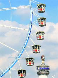 Visitors enjoy a ferris wheel ride at the Oktoberfest in Munich
