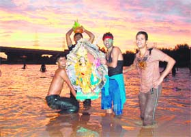 Devotees immerse an idol of Lord Vishwakarma at Bhankarpur village