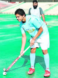 Manmeet Raj Singh takes tips from coach Gurminder Singh at the Sector 42 Hockey Stadium in Chandigarh