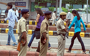 Policemen guard Connaught Place after the firing incident in Delhi on Sunday.