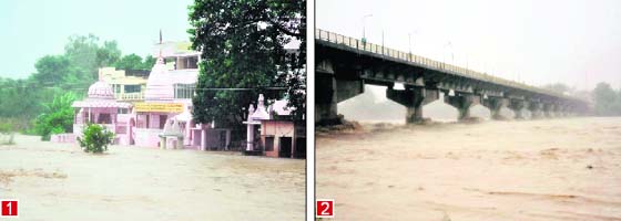 1. Inundated ashrams and (2) the Ganga in spate at the Chandi Ghat Bridge in Haridwar on Sunday. Tribune photos: Rameshwar Gaur