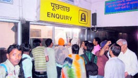 Passengers wait at the Dehradun railway station following cancellation of train services between Dehradun and Haridwar on Sunday.