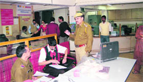 Investigating officers at the PNB branch in Sanjauli on Sunday.