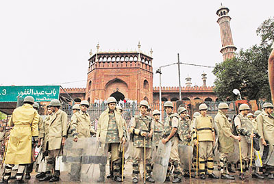 Police personnel stand guard at the site of firing near Jama Masjid in New Delhi on Sunday.