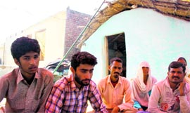 Tilak (left) and Gurdial (next to him) sit outside their hut in Gigriyal village of Khour block, 2 km from the Indo-Pak border.